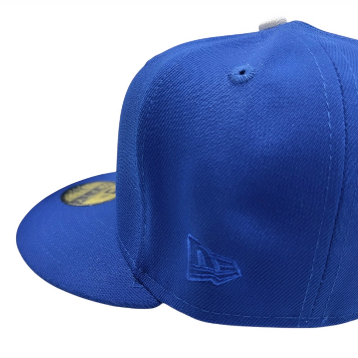 Blue baseball cap with New Era logo on a white background